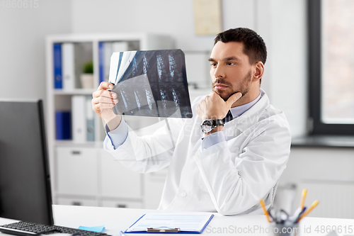 Image of male doctor with x-ray of spine at hospital