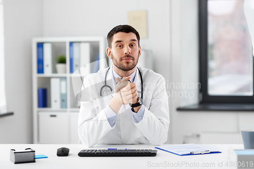 Image of happy male doctor with stethoscope at hospital