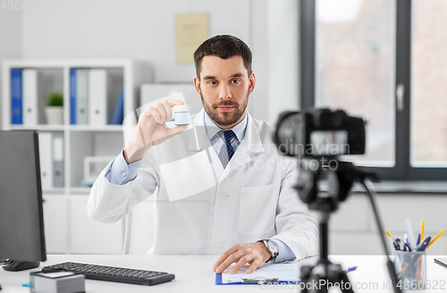 Image of doctor with drug recording video blog at hospital