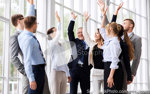 Image of business people celebrating success at office