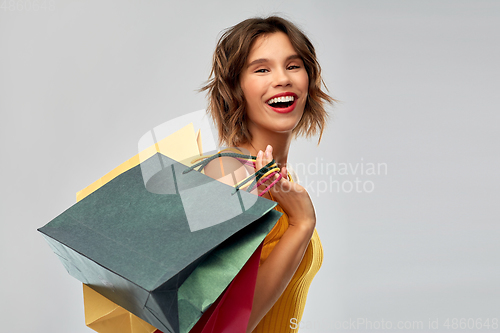 Image of happy smiling young woman with shopping bags