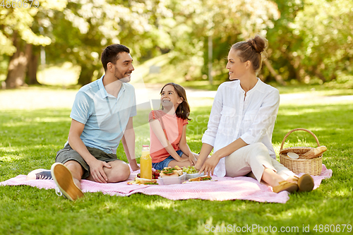 Image of happy family having picnic at summer park