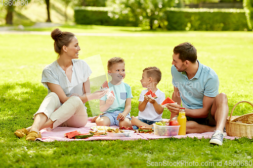 Image of happy family having picnic at summer park