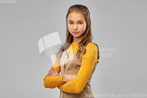 Image of serious young teenage girl with crossed arms