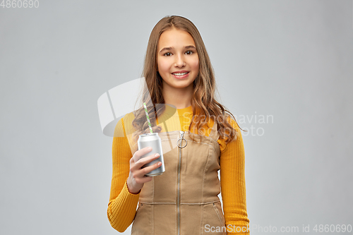 Image of happy teenage girl drinking soda from can