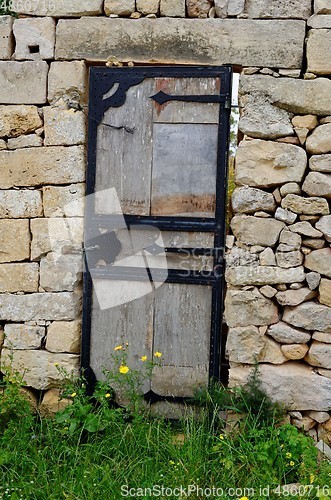 Image of Wooden door in the ancient stone wall