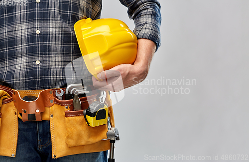 Image of worker or builder with helmet and working tools