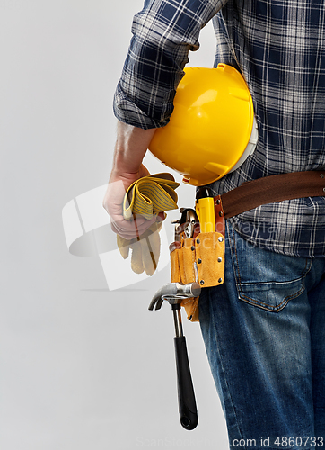 Image of worker or builder with helmet and working tools