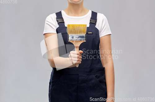 Image of close up of painter or builder with paint brush