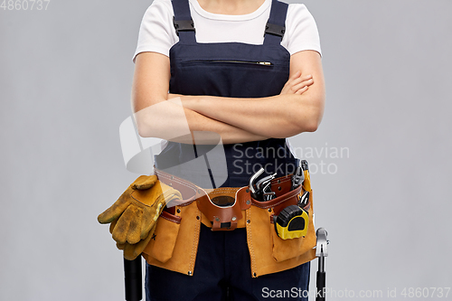 Image of woman or builder with working tools on belt