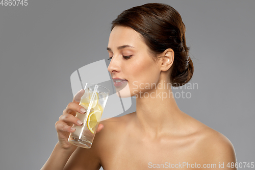 Image of woman drinking water with lemon and ice