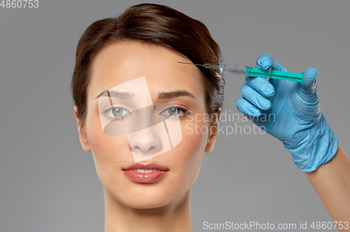 Image of beautiful young woman and hand with syringe