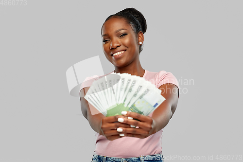 Image of happy african american woman with euro money