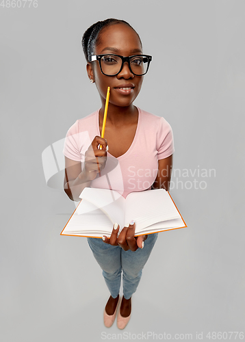 Image of happy african american woman with notebook