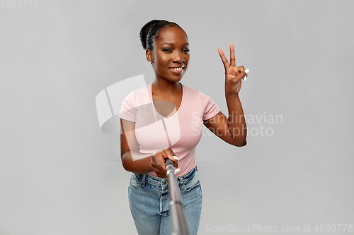 Image of happy african american woman taking selfie