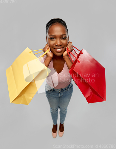 Image of happy african american woman with shopping bag