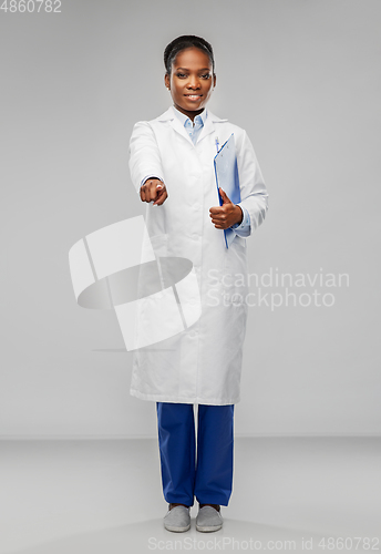 Image of african female doctor pointing finger to camera