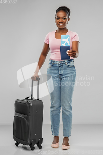Image of happy young woman with air ticket and travel bag