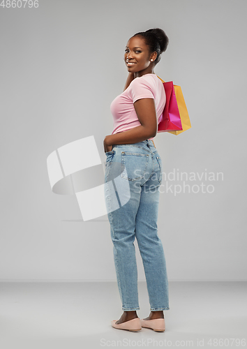 Image of happy african american woman with shopping bags