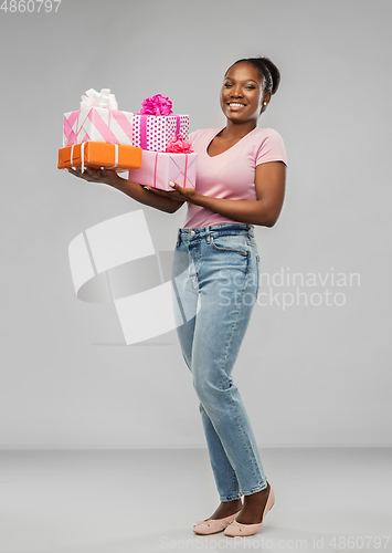 Image of happy african american woman with gift boxes