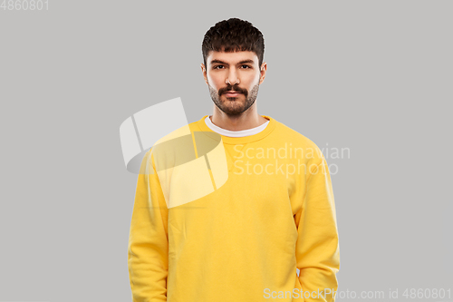 Image of young man in yellow sweatshirt