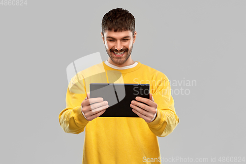 Image of smiling young man with tablet pc computer