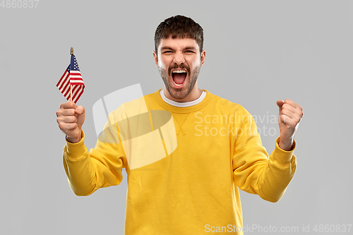 Image of man in yellow sweatshirt with flag of america