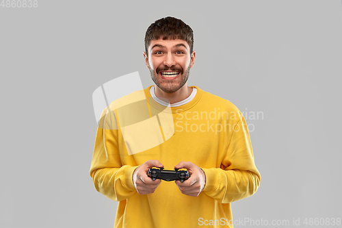 Image of man or gamer with gamepad playing video game