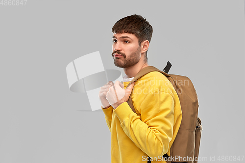 Image of sad unhappy young man with backpack