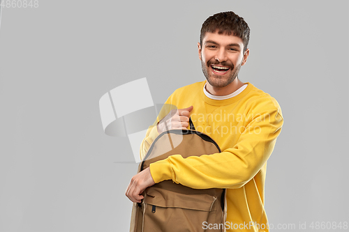 Image of happy smiling young man with backpack