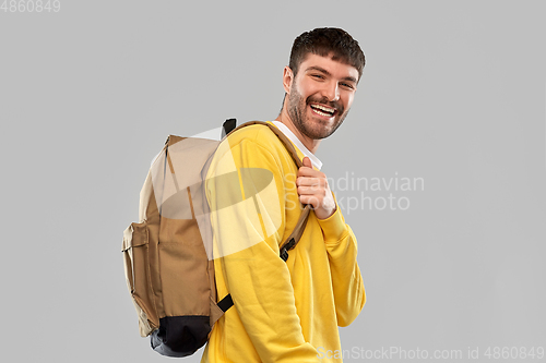 Image of happy smiling young man with backpack
