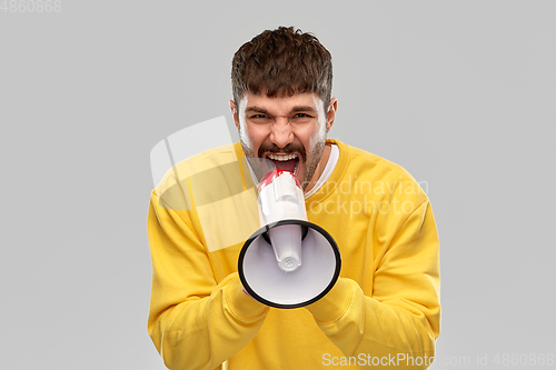 Image of angry man shouting to megaphone