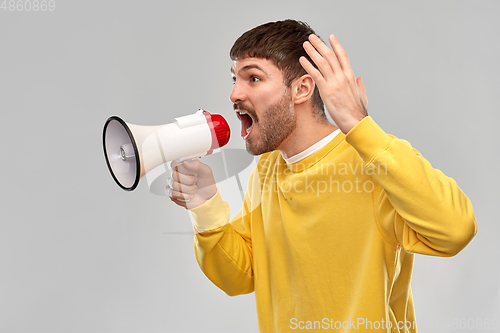 Image of angry man shouting to megaphone