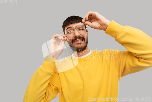 Image of goofy young man in glasses and yellow sweatshirt