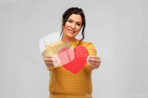 Image of happy smiling young woman with red heart