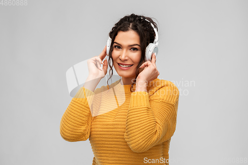 Image of happy woman in headphones listening to music