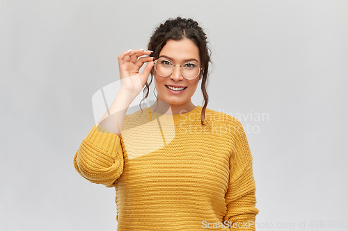 Image of happy smiling young woman in glasses