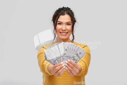 Image of happy smiling young woman with dollar money