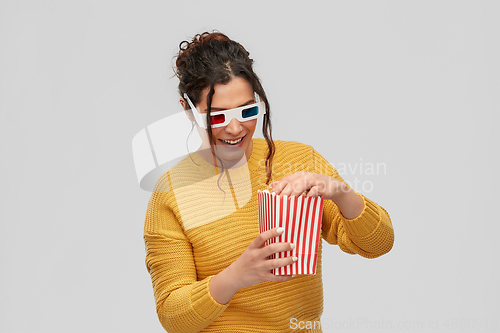 Image of happy woman in 3d movie glasses with popcorn