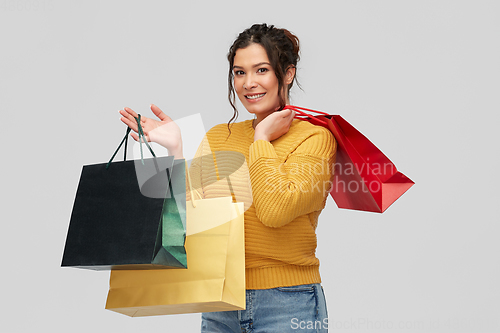 Image of happy smiling young woman with shopping bags