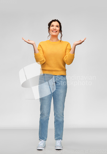 Image of happy grateful woman looking up