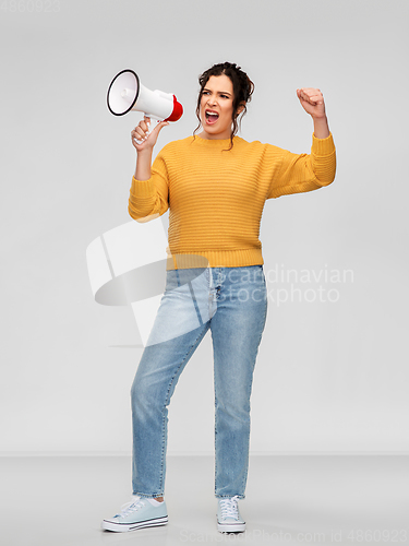 Image of angry young woman speaking to megaphone