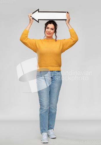 Image of happy young woman with big white thick left arrow