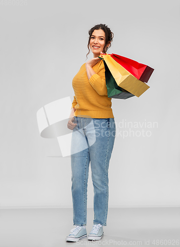 Image of happy smiling young woman with shopping bags