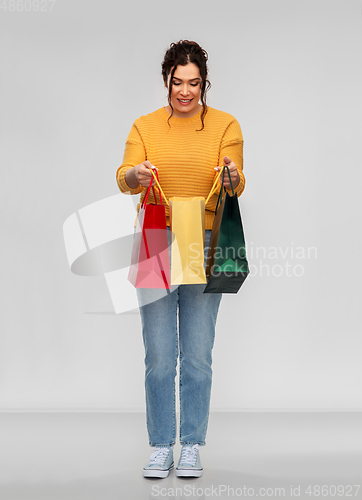 Image of happy smiling young woman with shopping bags