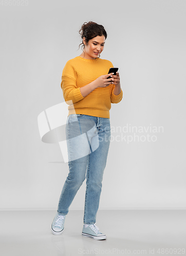 Image of happy woman using smartphone