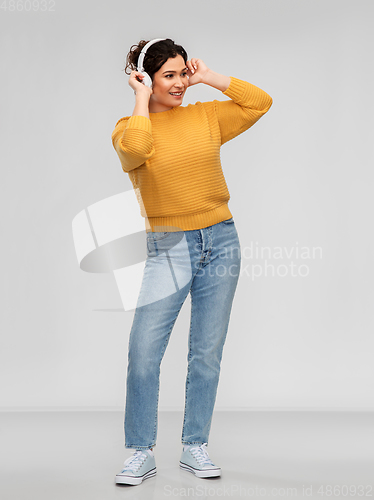 Image of happy woman in headphones listening to music