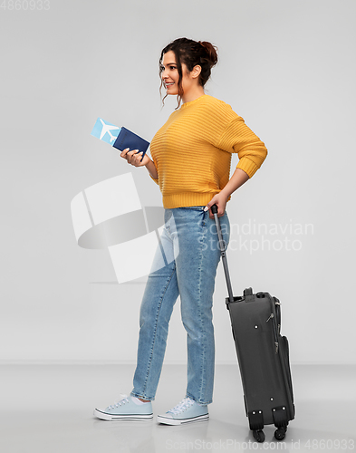 Image of woman with passport, air ticket and travel bag