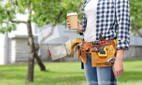 Image of woman with takeaway coffee cup and working tools