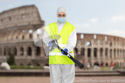 Image of sanitation worker in hazmat with pressure washer